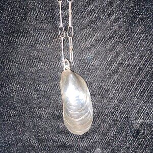 Silver tone pendant in shape of a shell